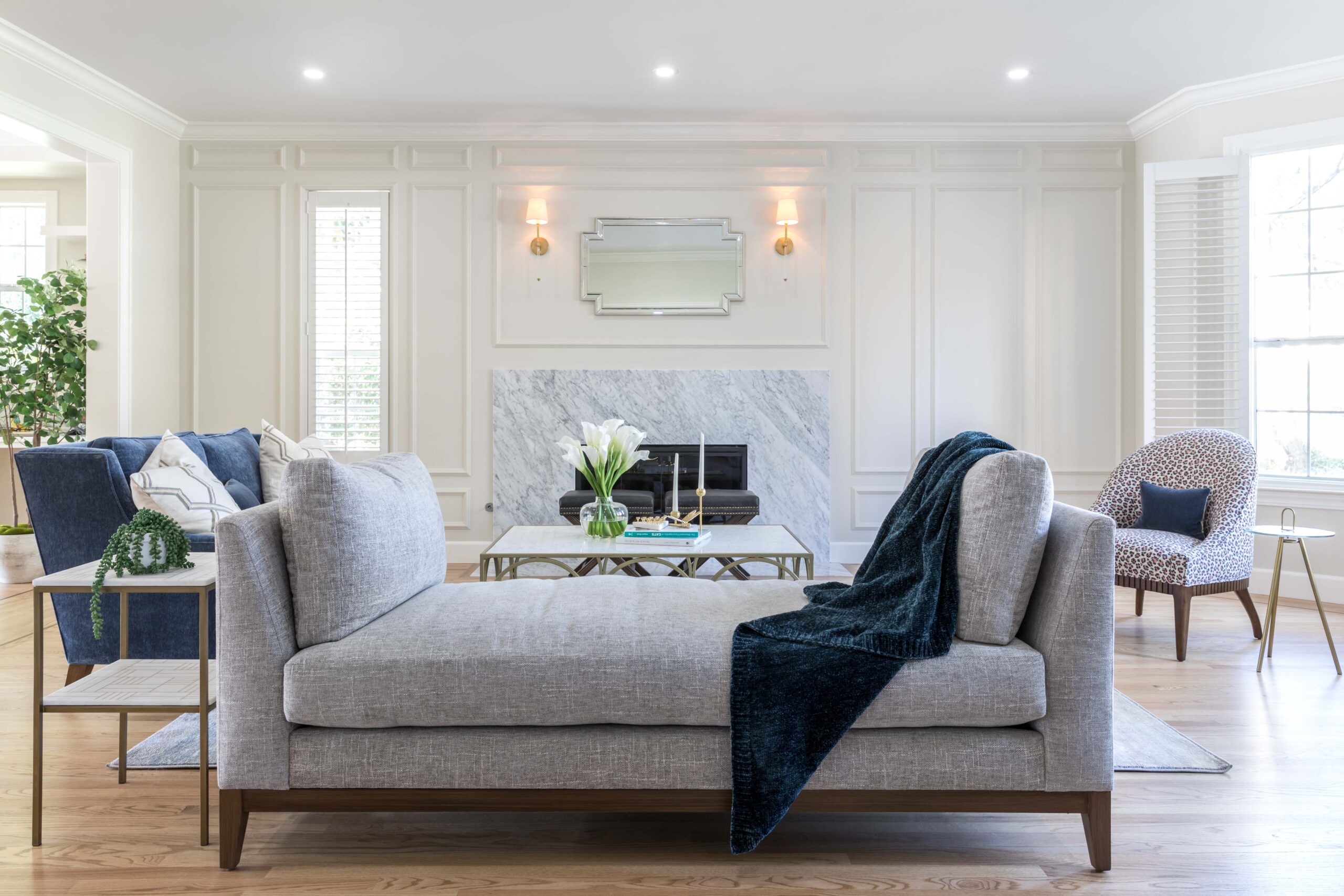 Transitional living room with moulding on the fireplace wall.