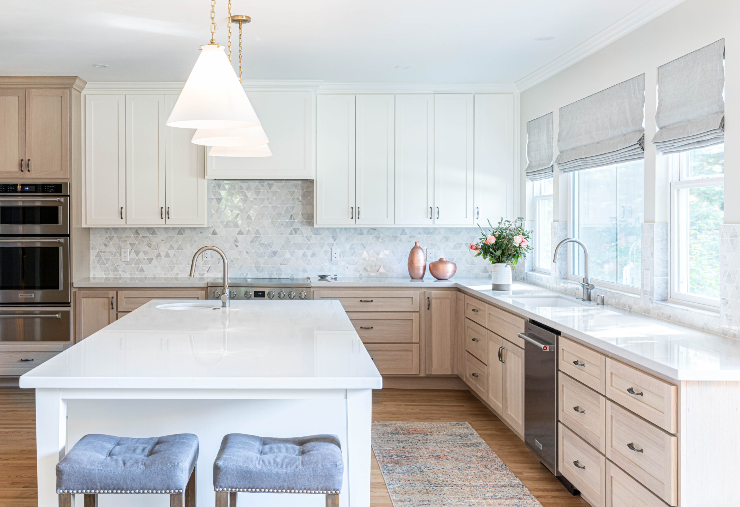 Kitchen with white oak lower cabinets and white upper cabinets and island.