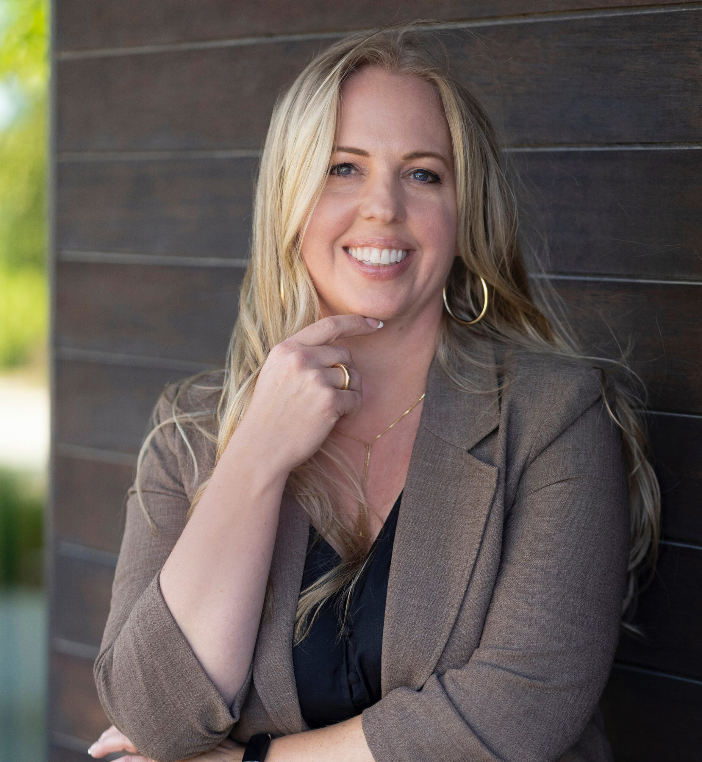 Photo of Rebecca Ward facing the camera with a dark background